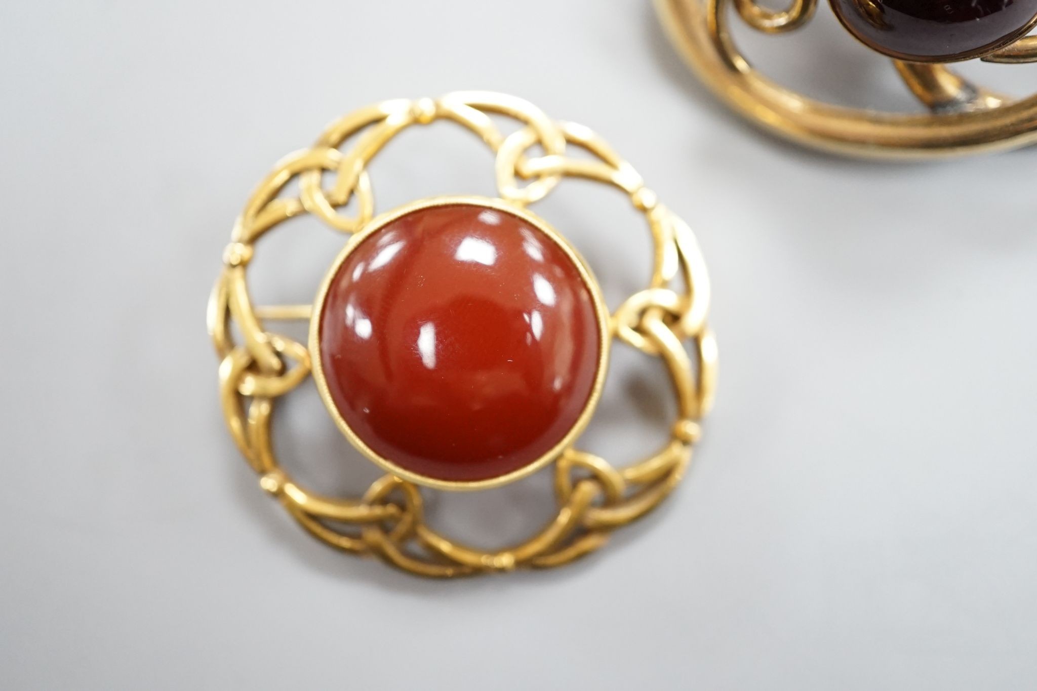 A late Victorian Scottish 9ct gold and carnelian set Iona brooch, 36mm, gross 10.1 grams and a Victorian mourning brooch.